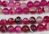 CAG2085 15.5 inches 6mm faceted round fuchsia line agate beads